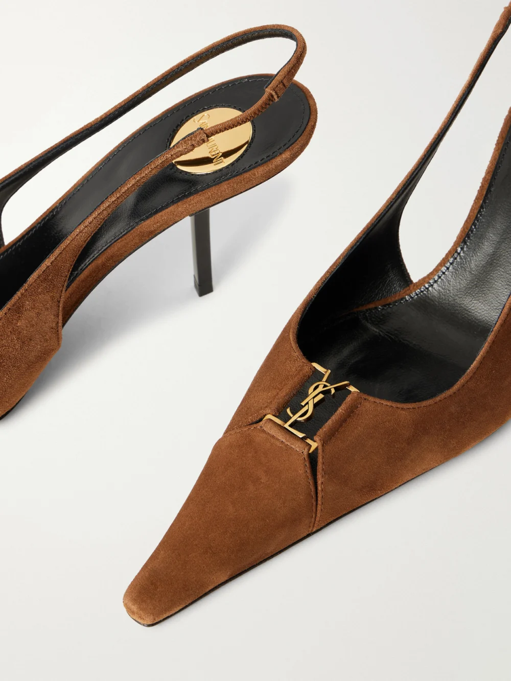 Close-up detail of the Saint Laurent Babylone Cassandre-embellished Suede Slingback Pumps