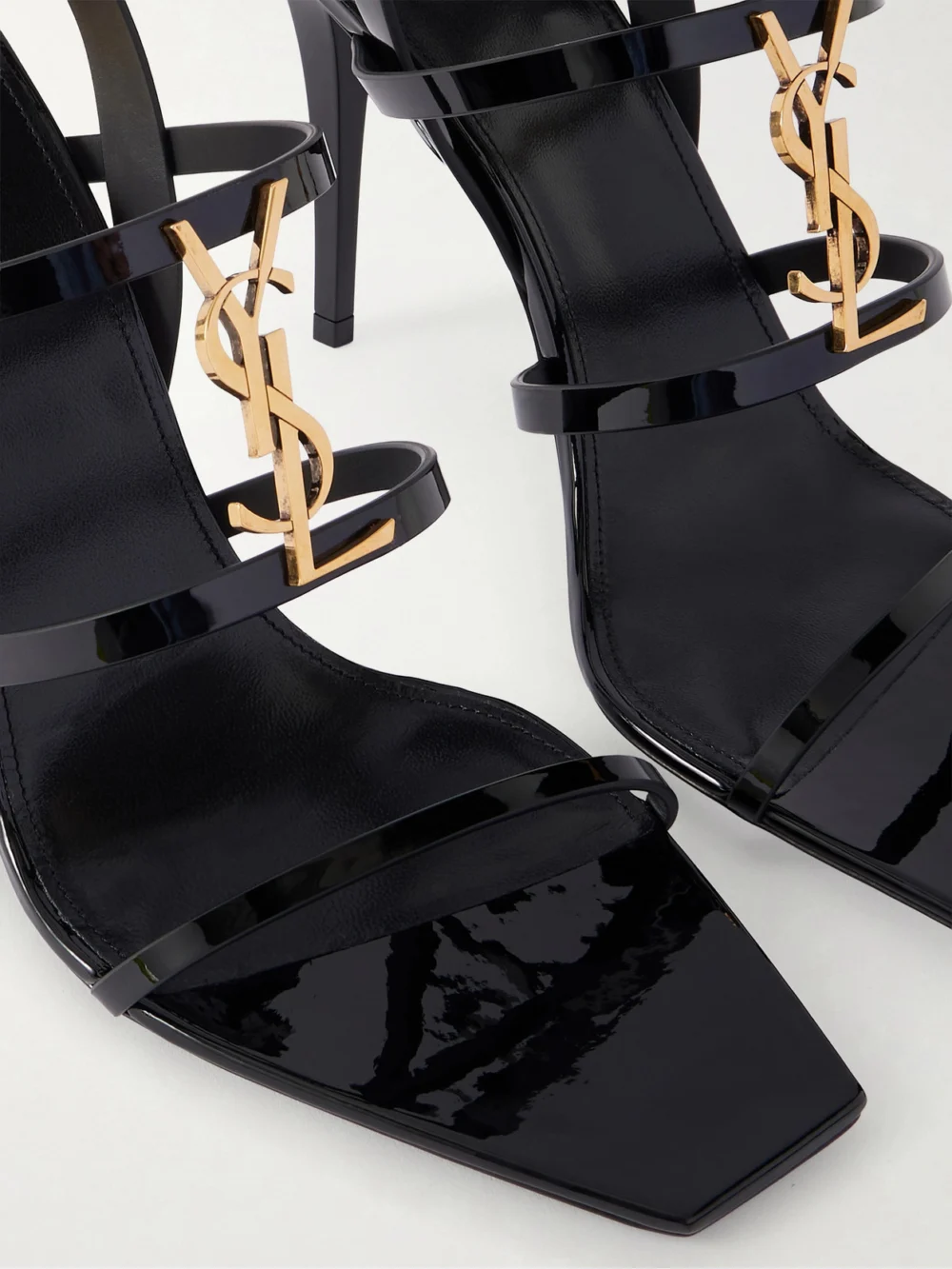 Close-up detail of the Saint Laurent Cassandra Embellished Patent-leather Pumps