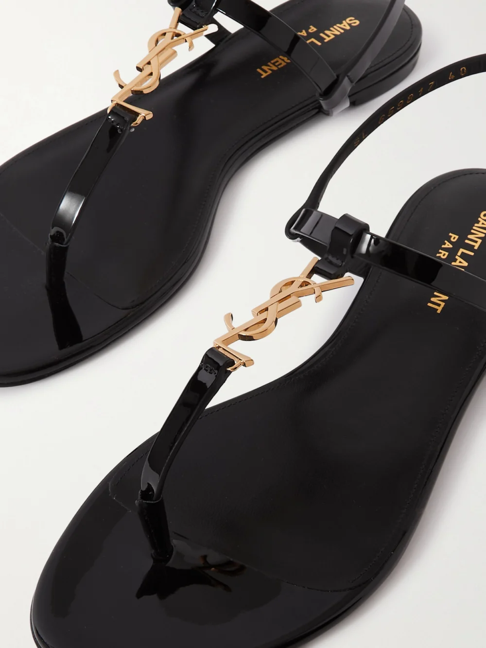 Close-up detail of the Saint Laurent Cassandra Embellished Patent-leather Slingback Sandals
