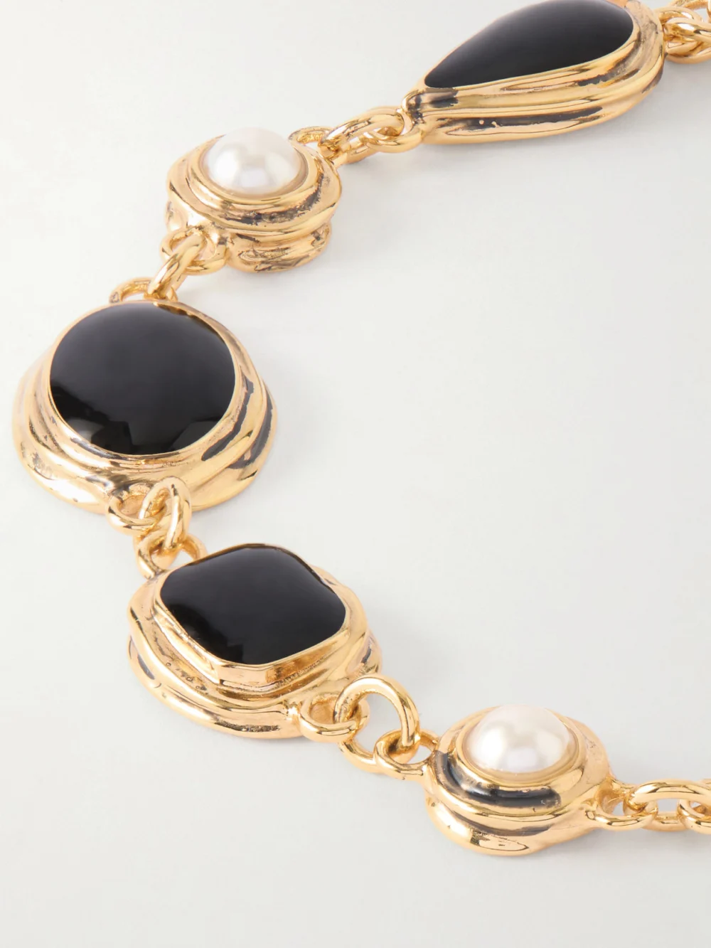 Close-up detail of the Saint Laurent Cassandre Gold-tone Enamel Bracelet