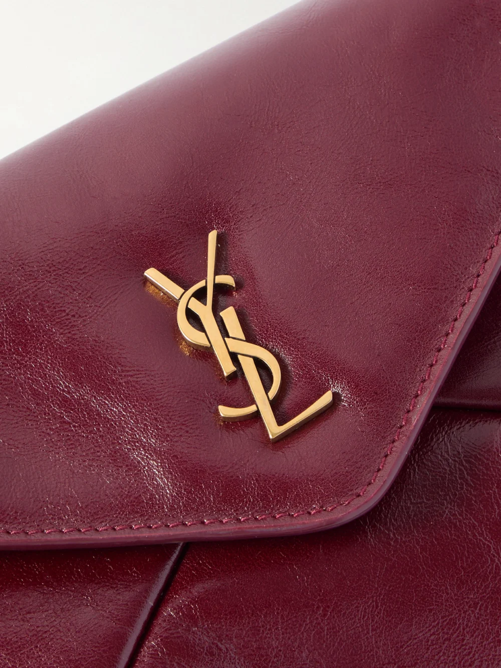 Close-up detail of the Saint Laurent Cassandre Large Glossed-leather Clutch