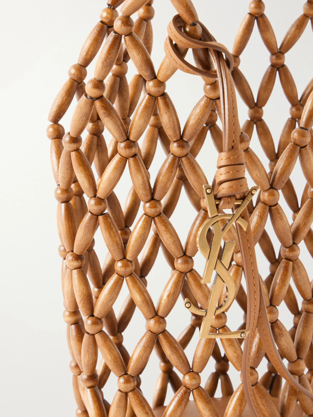 Close-up detail of the Saint Laurent Cassandre Mini Beaded Wood Bucket Bag