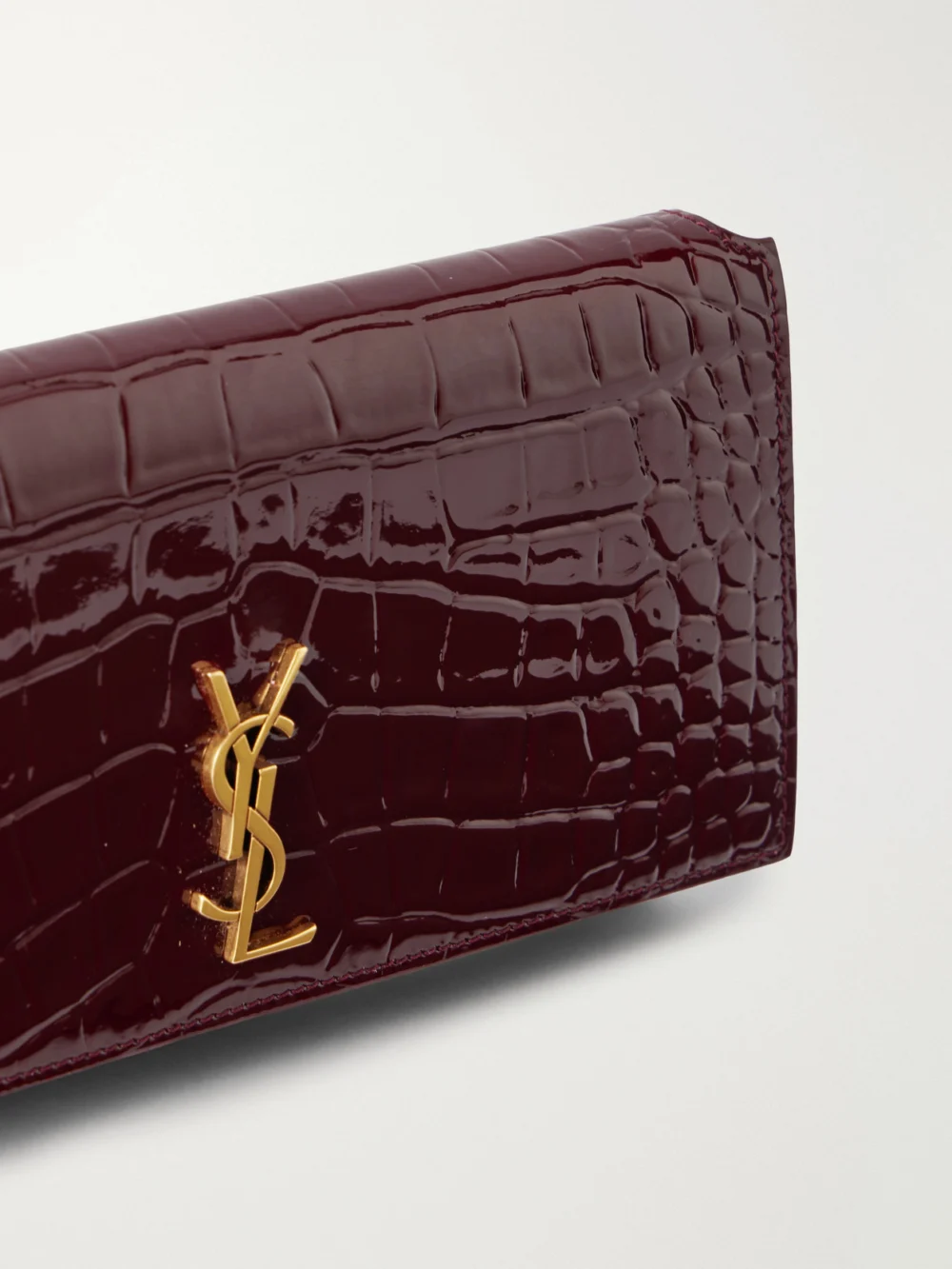 Close-up detail of the Saint Laurent Cassandre Strap Croc-effect Patent Leather Clutch