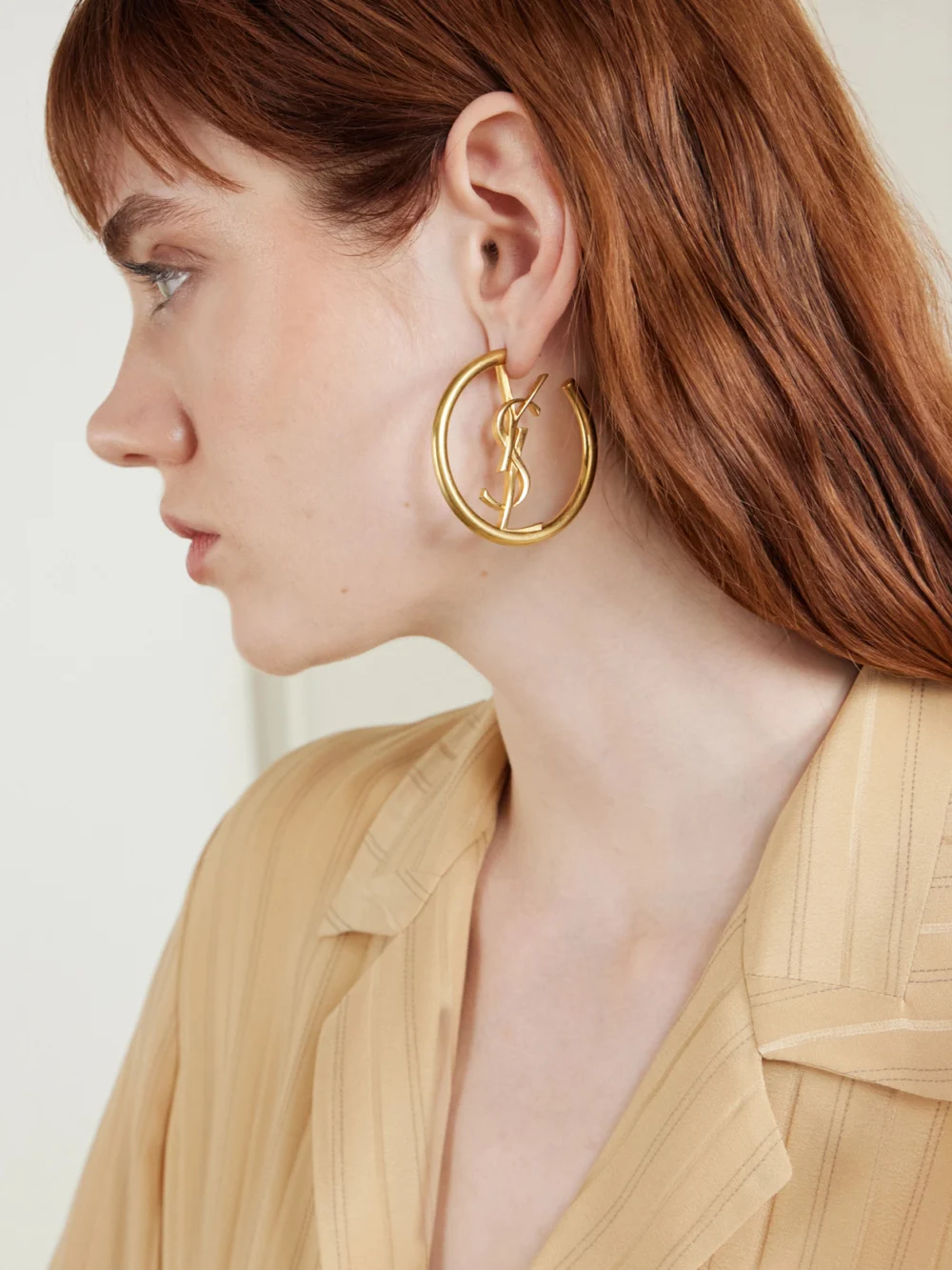 Saint Laurent Créoles Cassandre Brass Earrings, styled view