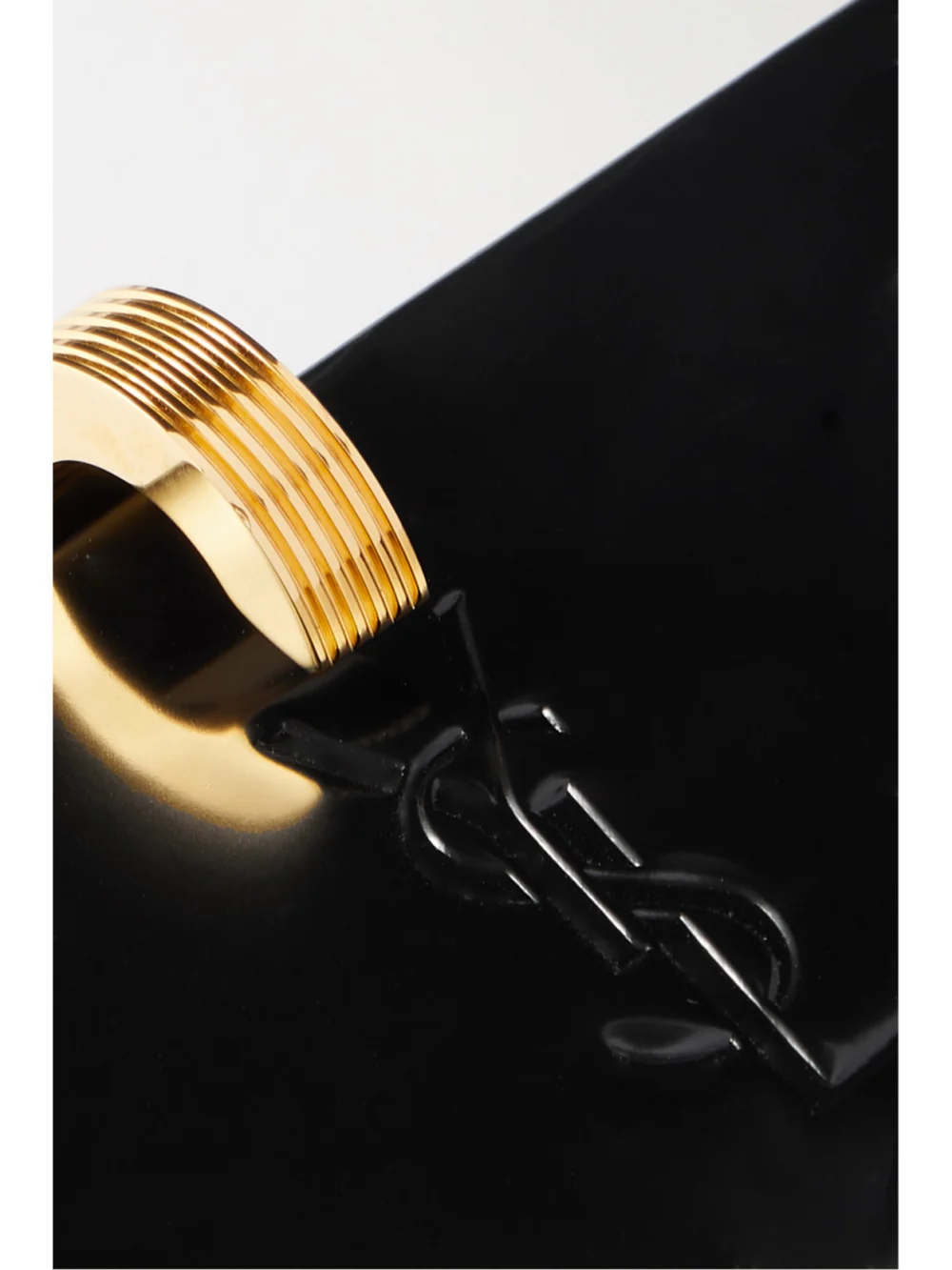 Close-up detail of the Saint Laurent Daria Patent-leather Clutch