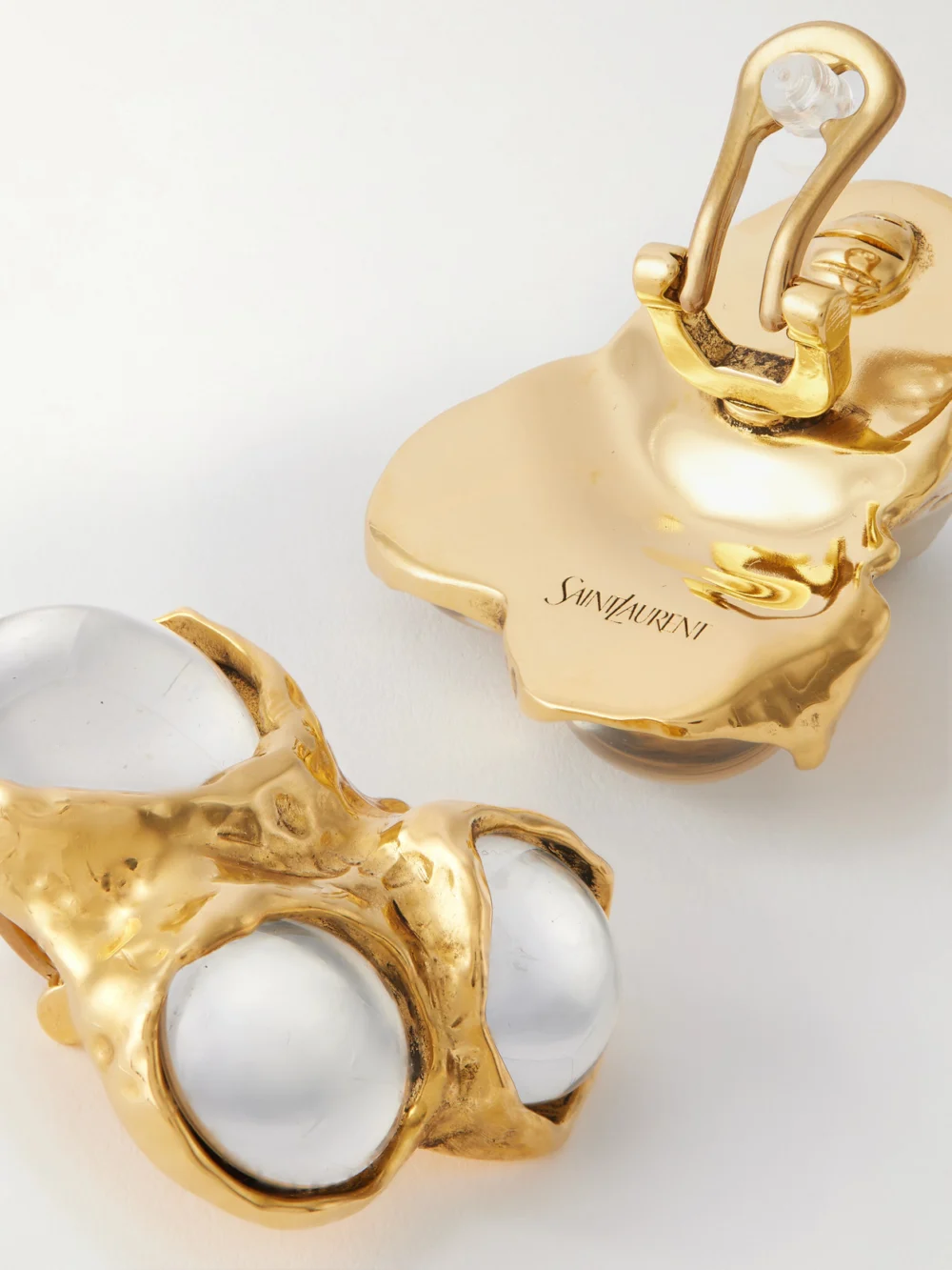 Close-up detail of the Saint Laurent Gold-tone and Resin Clip Earrings