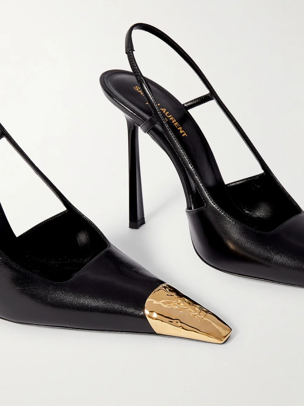 Close-up detail of the Saint Laurent Jeanne Cassandre-embellished Glossed-leather Slingback Pumps