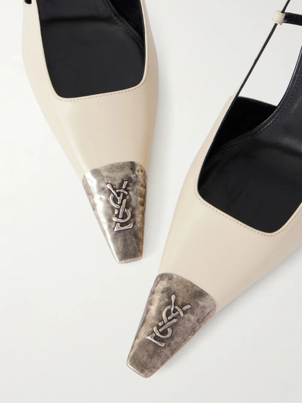 Close-up detail of the Saint Laurent Jeanne Cassandre-embossed Leather Slingback Pumps