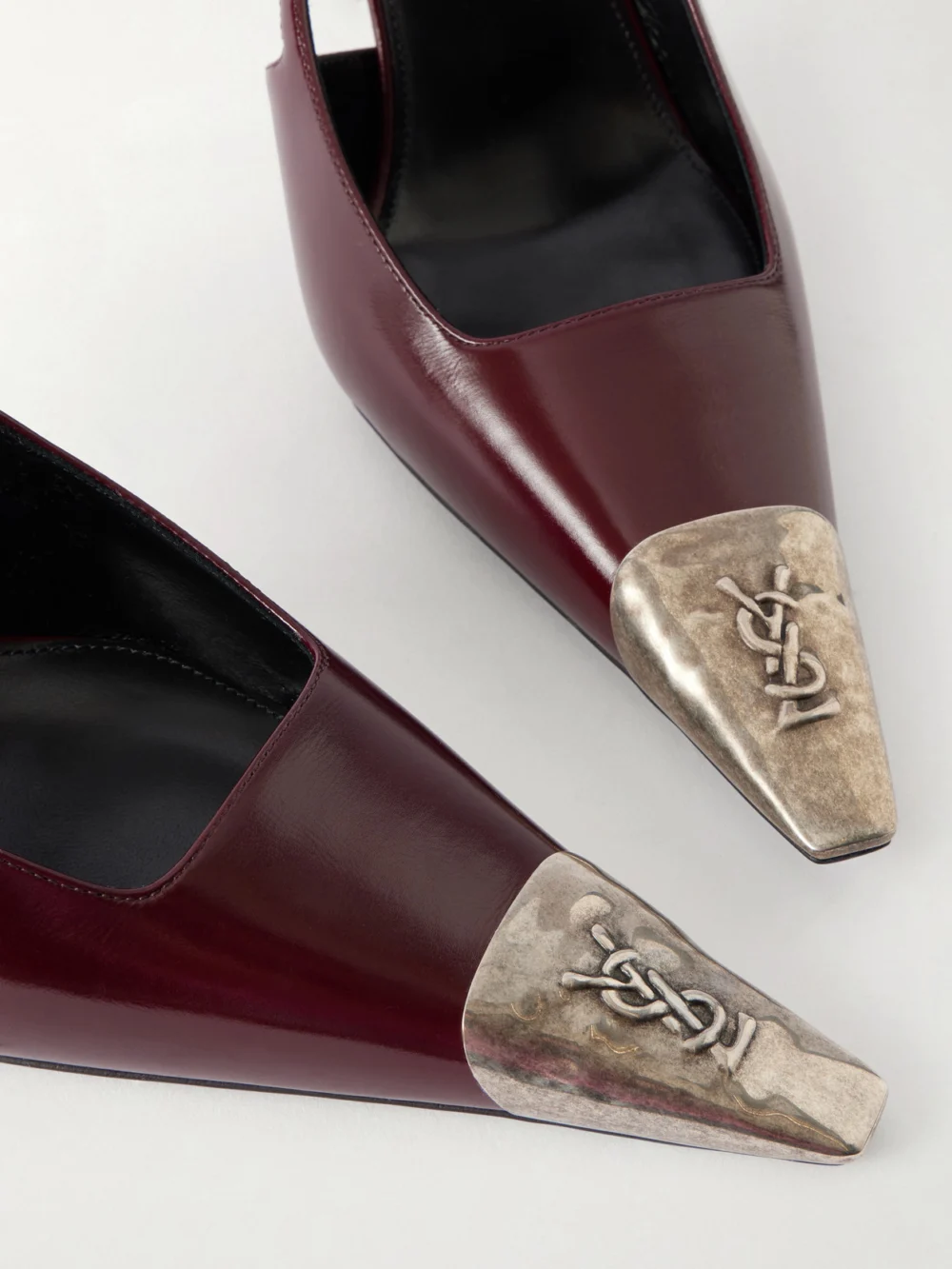 Close-up detail of the Saint Laurent Jeanne Cassandre-embossed Leather Slingback Pumps