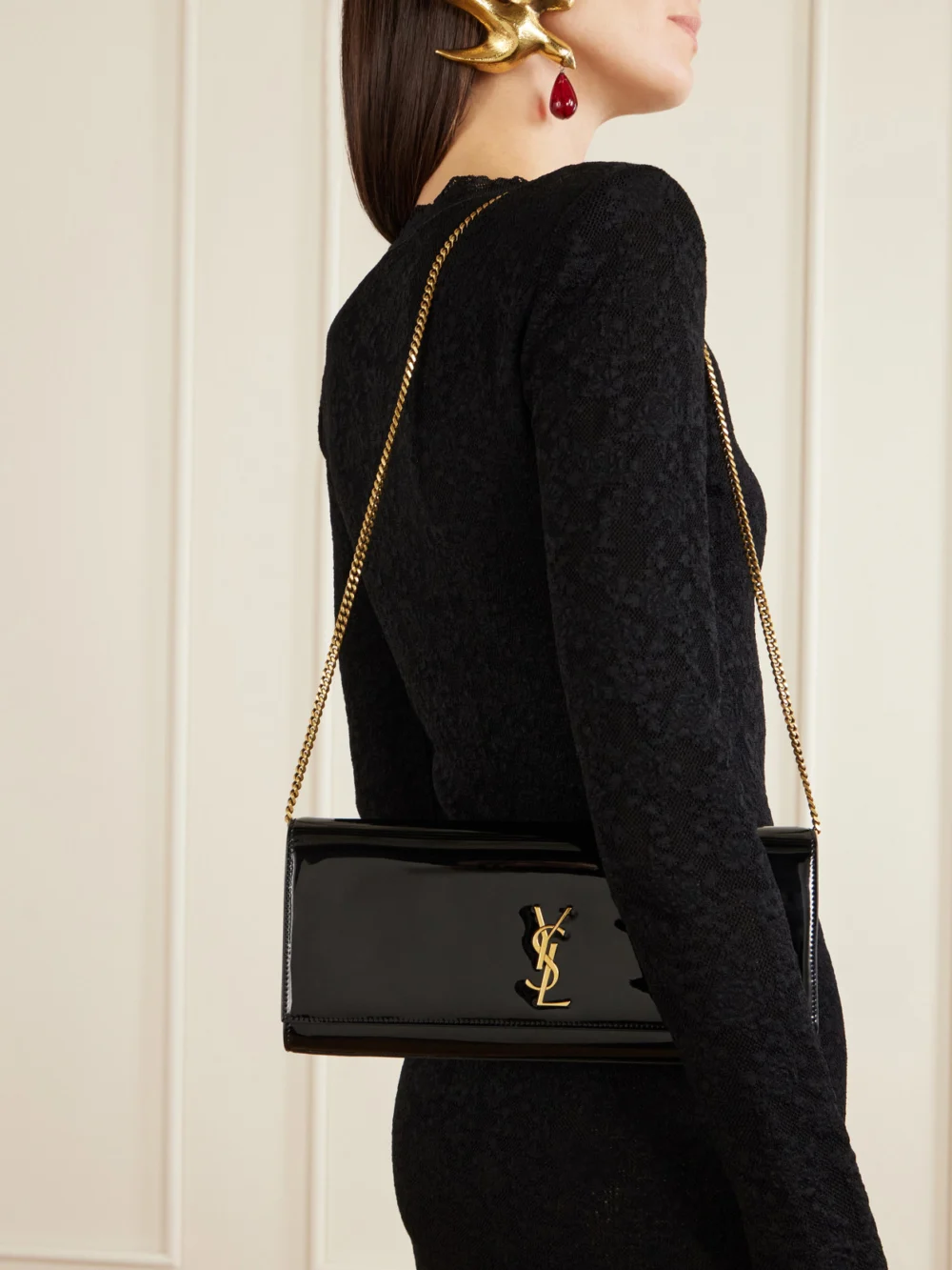 Saint Laurent Kate Cassandre-embellished Patent-leather Clutch, styled view