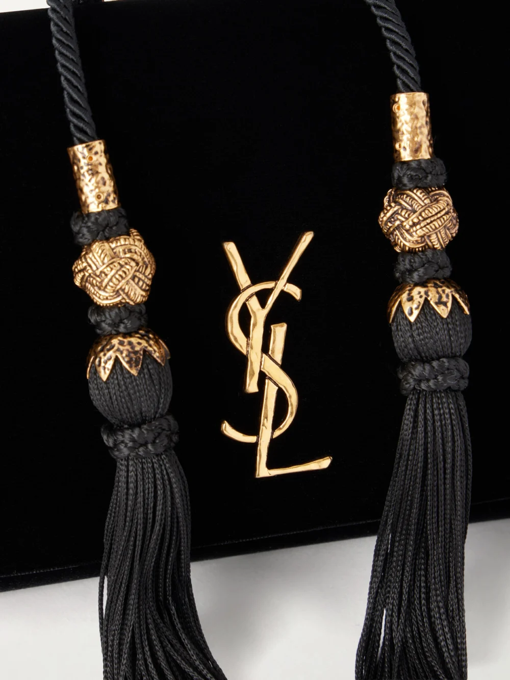 Close-up detail of the Saint Laurent Kate Cassandre-embellished Tasseled Velvet Shoulder Bag