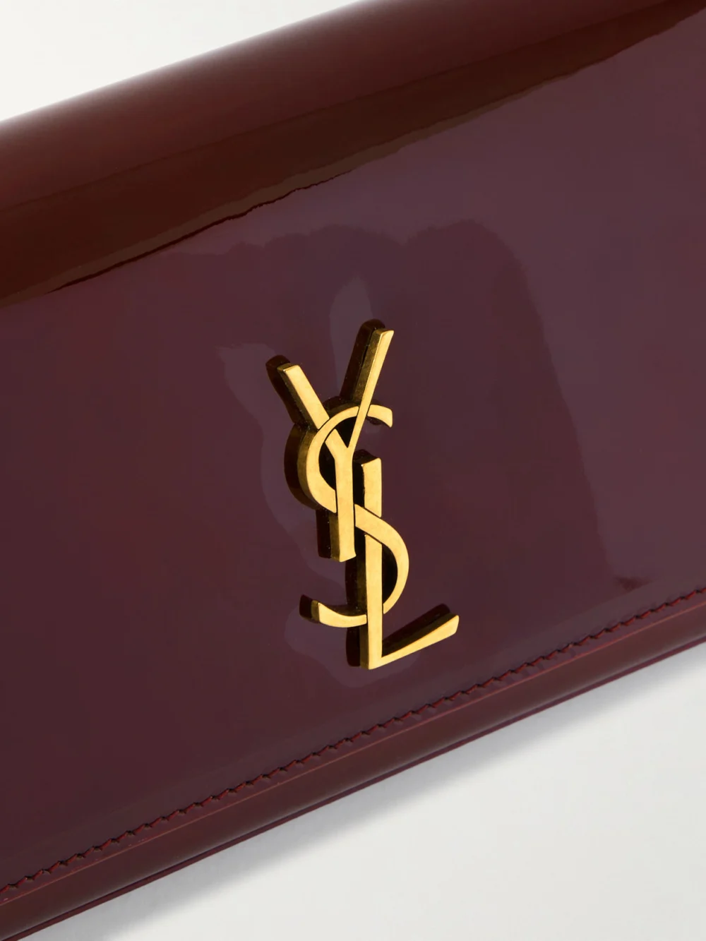 Close-up detail of the Saint Laurent Kate Patent-leather Clutch
