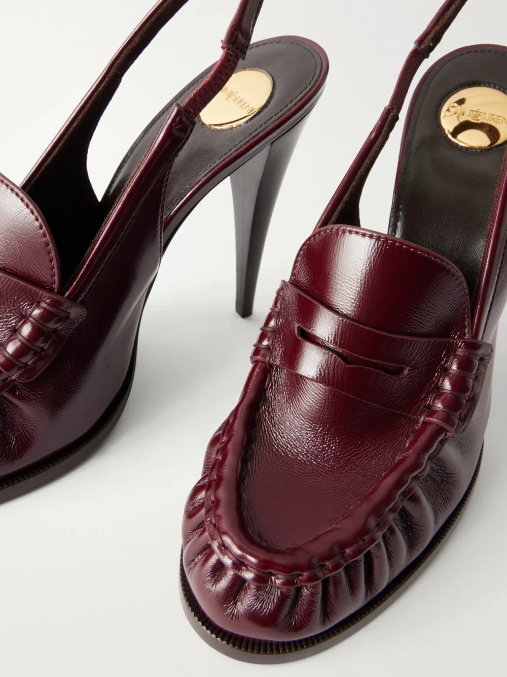 Close-up detail of the Saint Laurent Le Loafer 110 Cassandre-embellished Leather Slingback Pumps