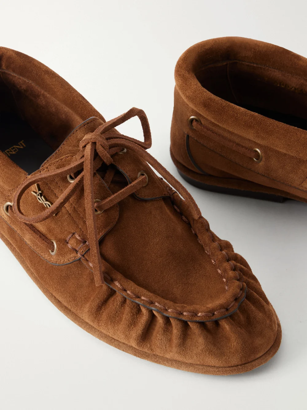 Close-up detail of the Saint Laurent Le Loafer Bateau Cassandre-embellished Suede Loafers