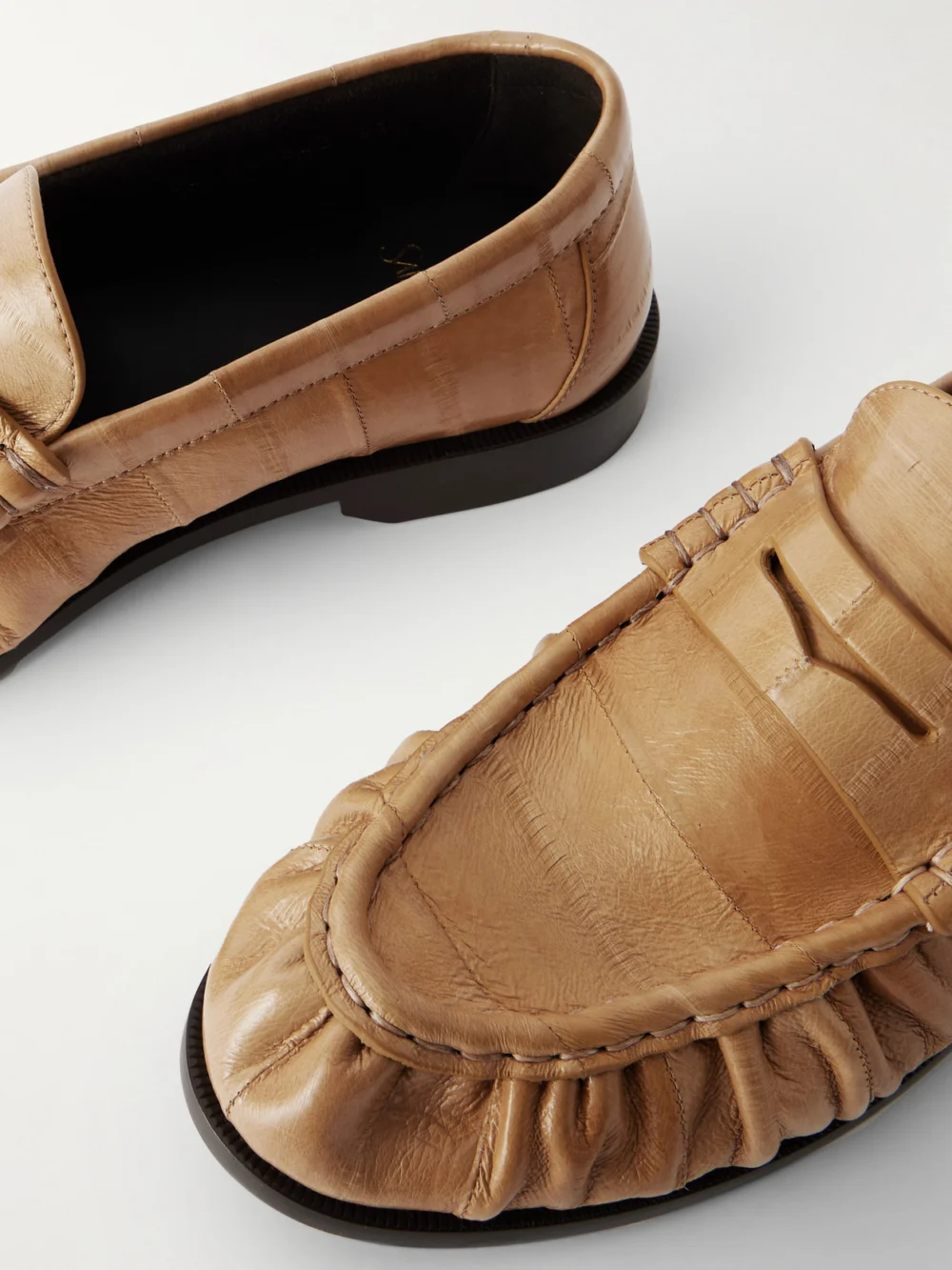 Close-up detail of the Saint Laurent Le Loafer Cassandre-embellished Eel Loafers