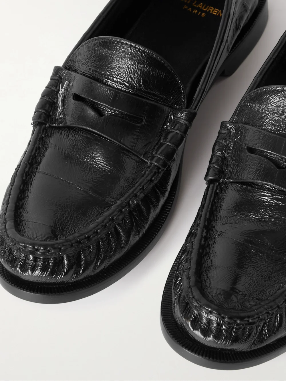 Close-up detail of the Saint Laurent Le Loafer Cassandre-embellished Eel Loafers