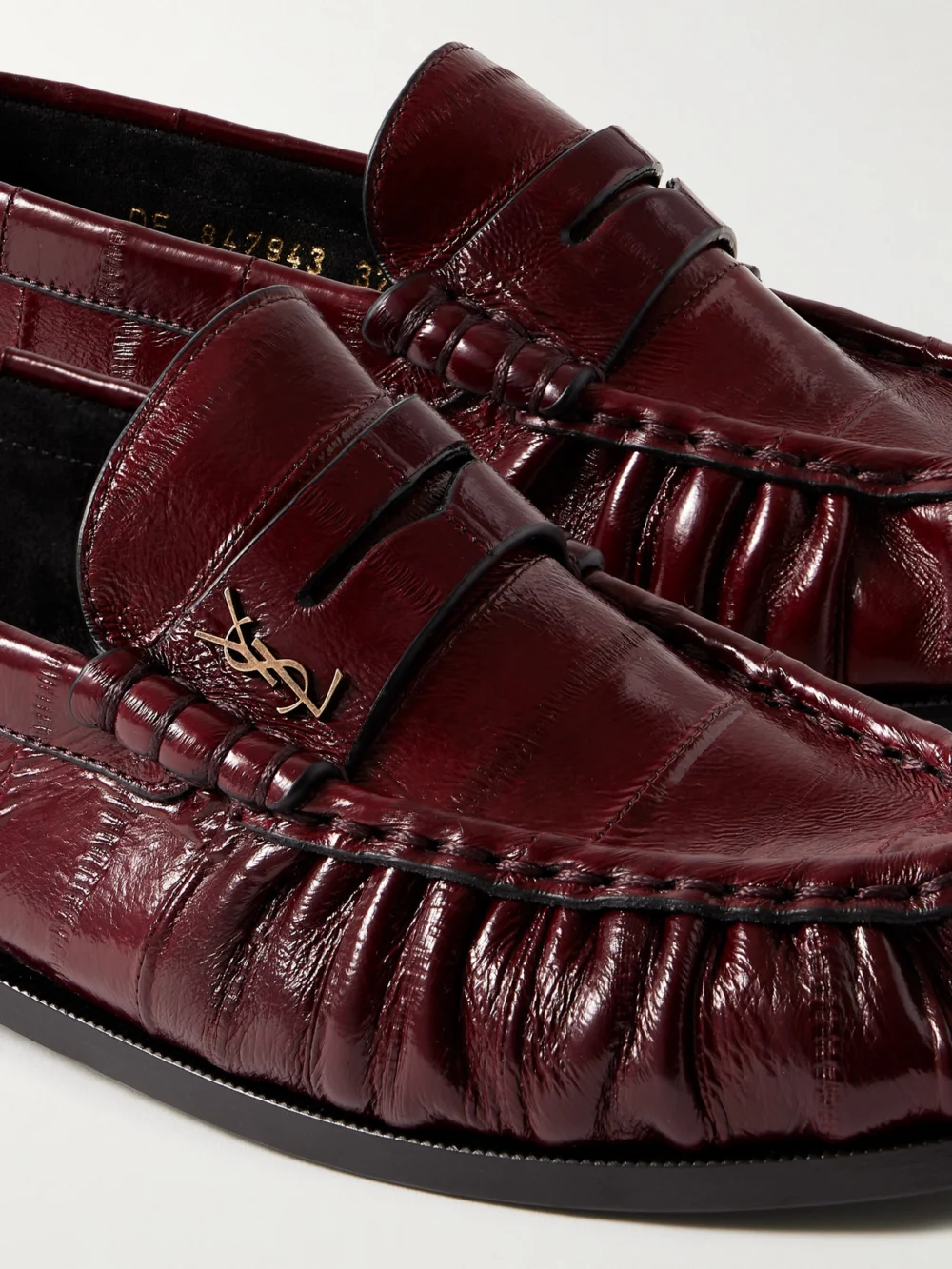 Close-up detail of the Saint Laurent Le Loafer Cassandre-embellished Eel Loafers
