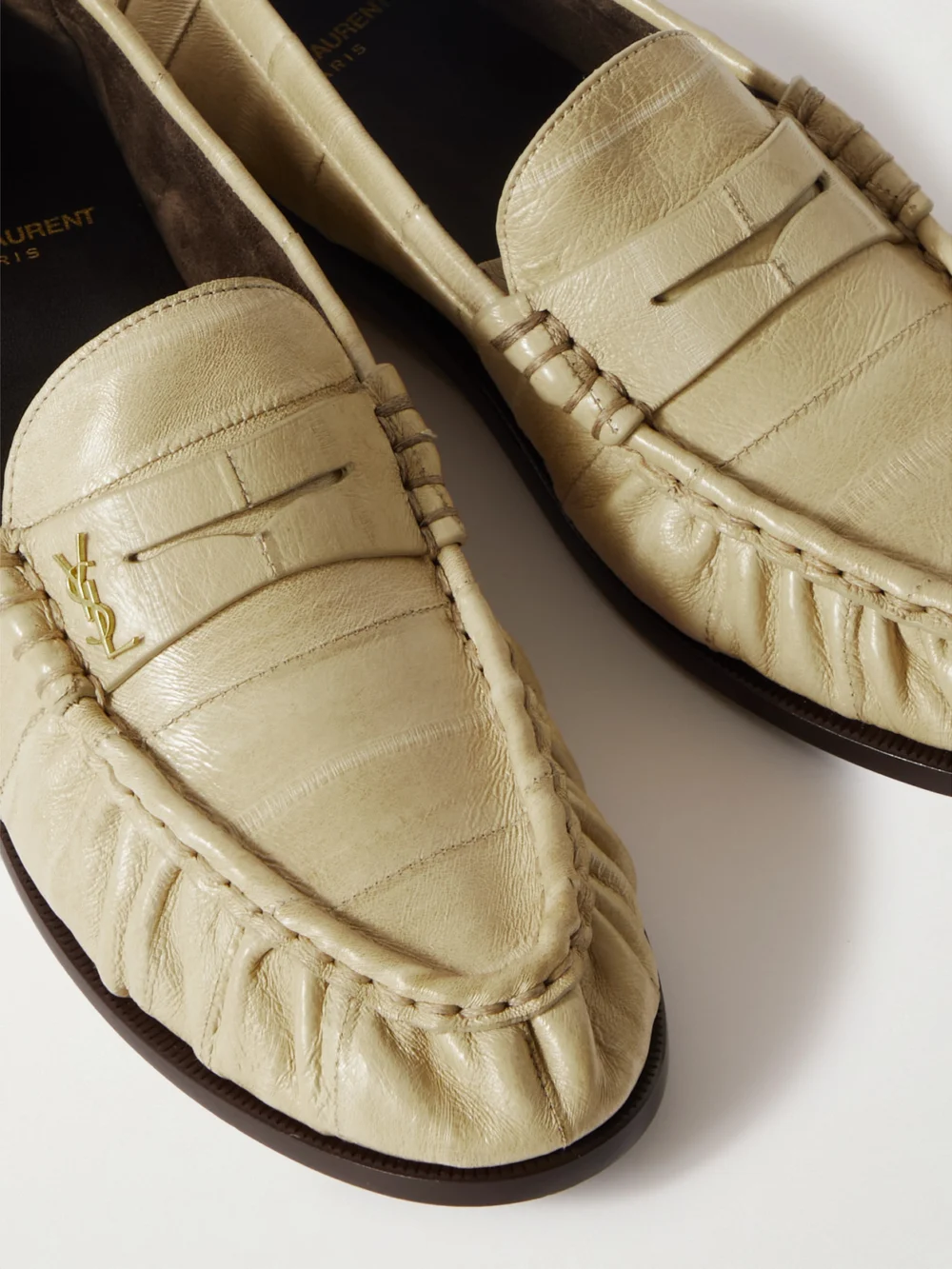 Close-up detail of the Saint Laurent Le Loafer Cassandre-embellished Eel Loafers