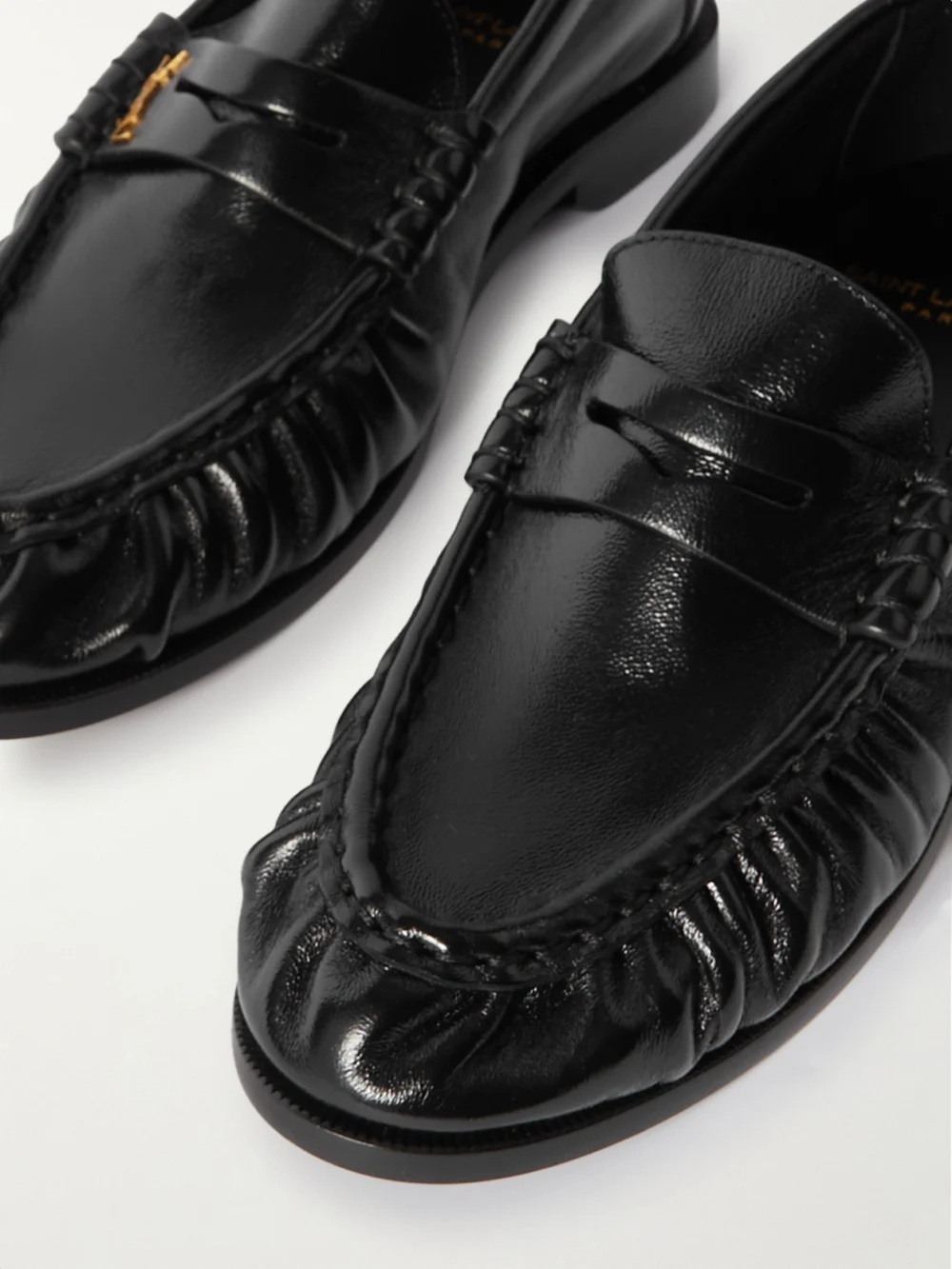 Close-up detail of the Saint Laurent Le Loafer Cassandre-embellished Leather Loafers