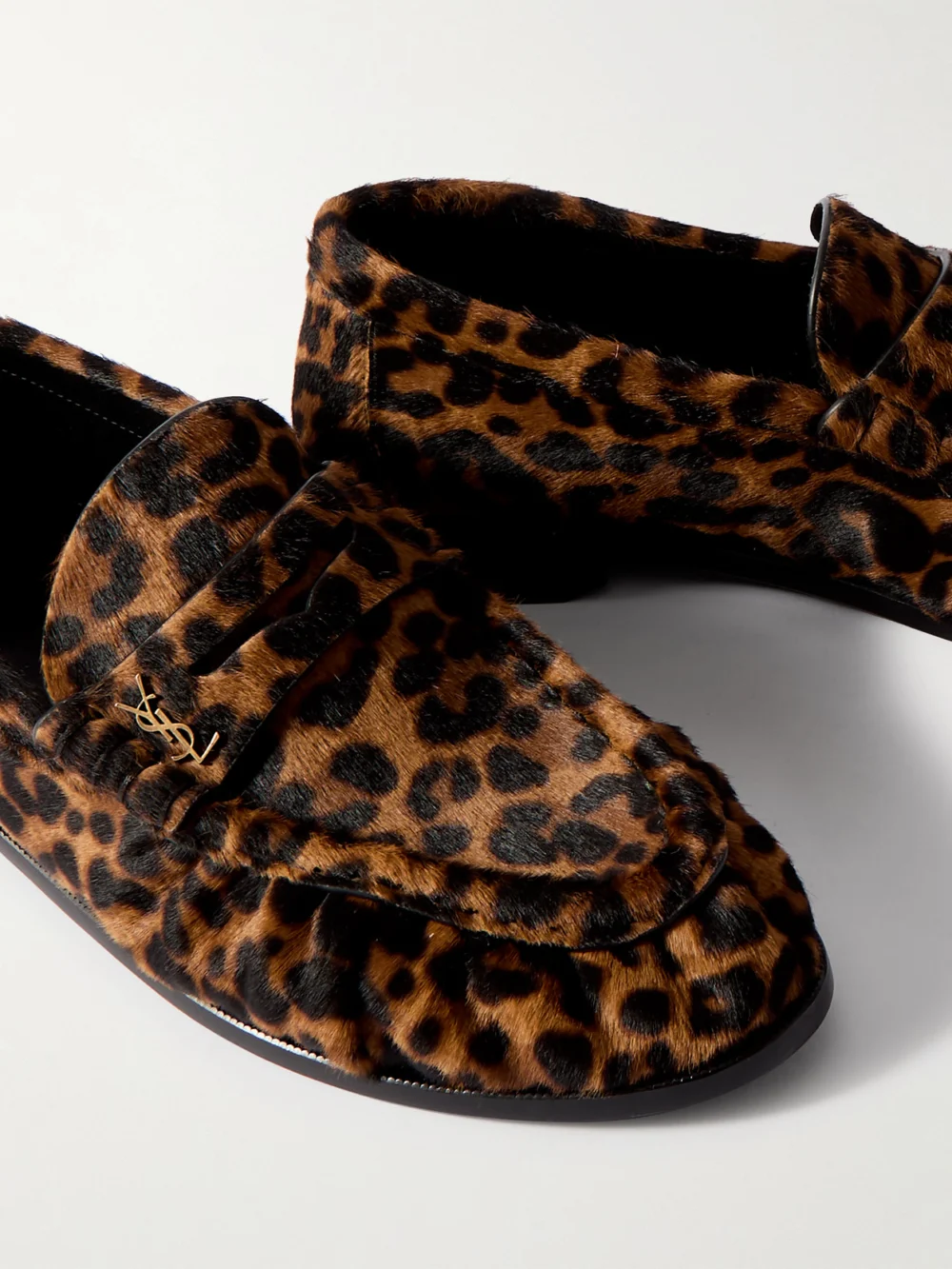 Close-up detail of the Saint Laurent Le Loafer Cassandre-embellished Leopard-print Calf Hair Loafers