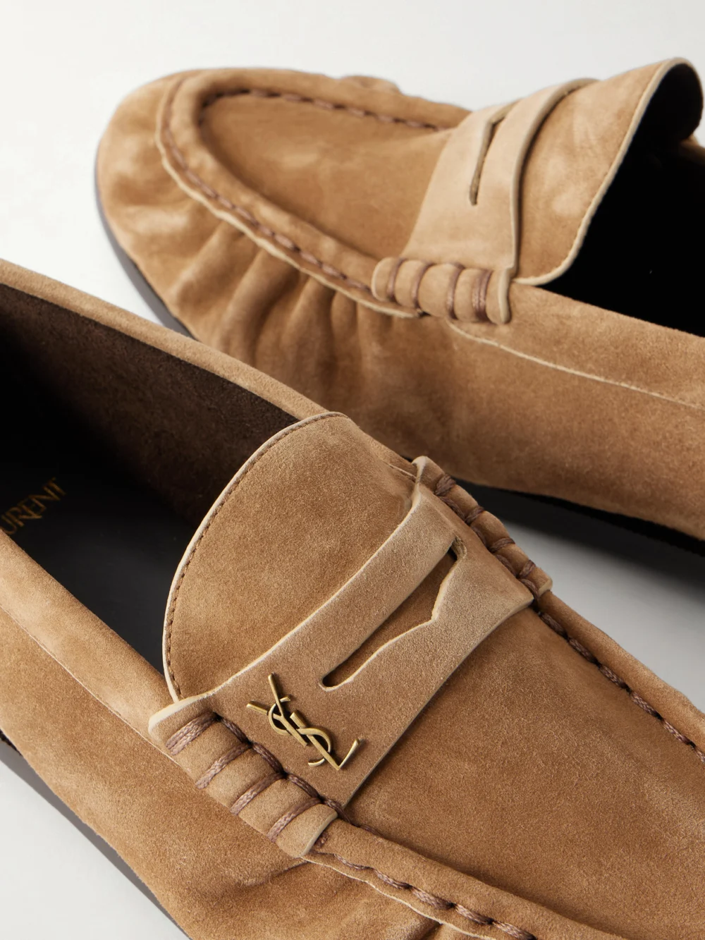 Close-up detail of the Saint Laurent Le Loafer Cassandre-embellished Suede Loafers