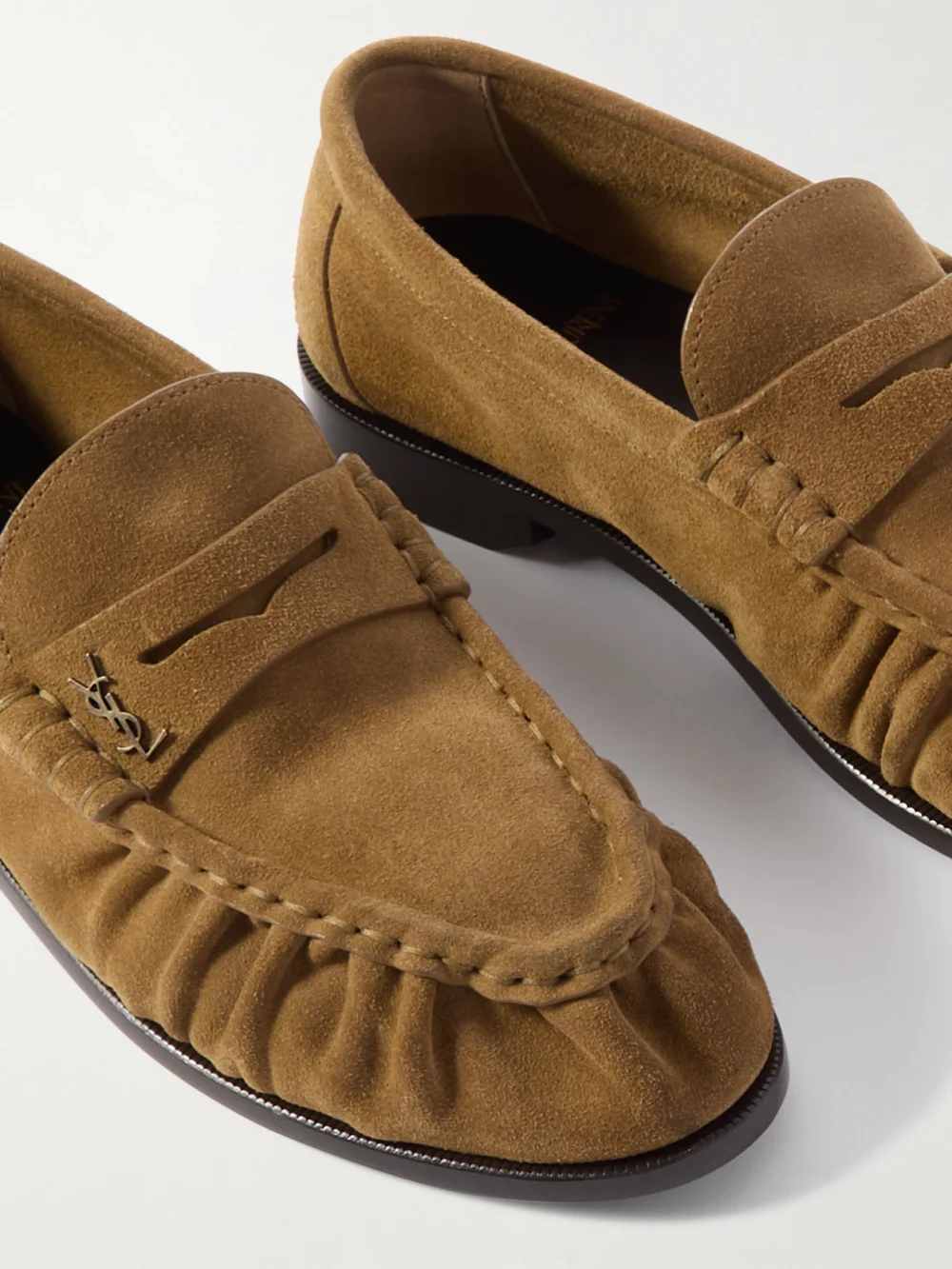 Close-up detail of the Saint Laurent Le Loafer Cassandre-embellished Suede Loafers