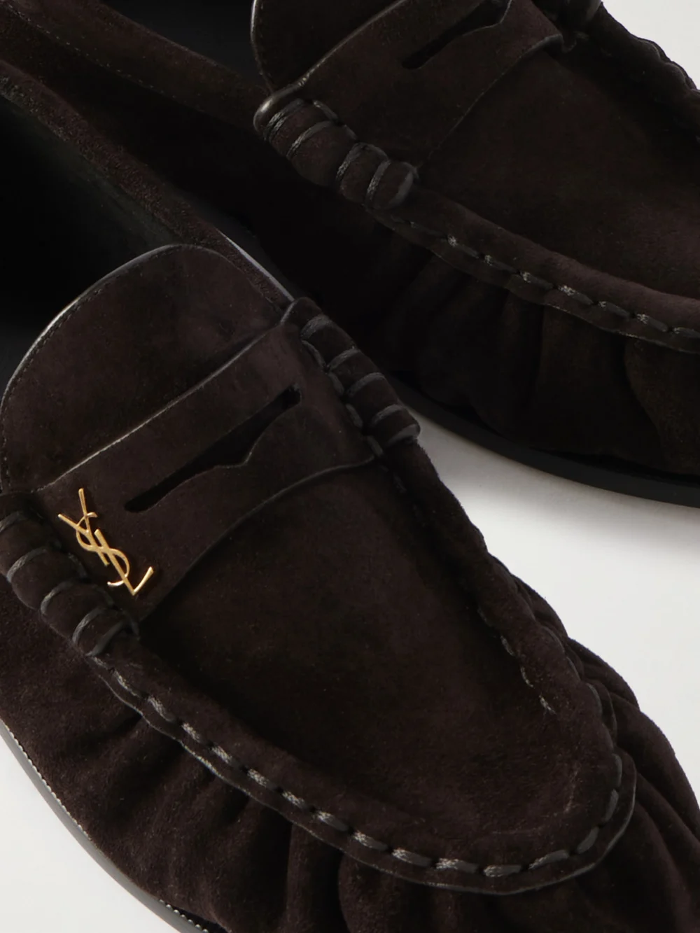Close-up detail of the Saint Laurent Le Loafer Cassandre-embellished Suede Loafers