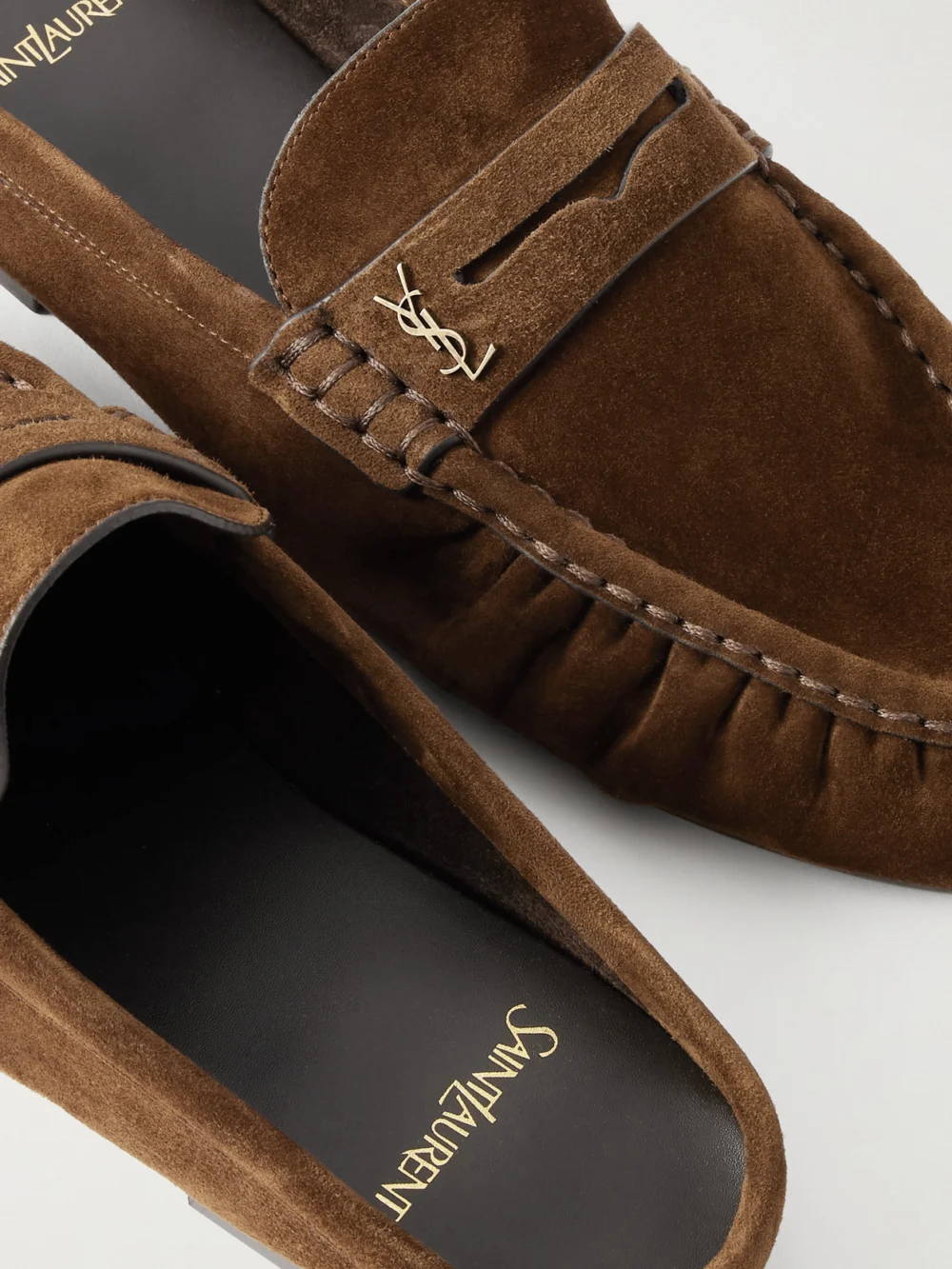 Close-up detail of the Saint Laurent Le Loafer Cassandre-embellished Suede Mules