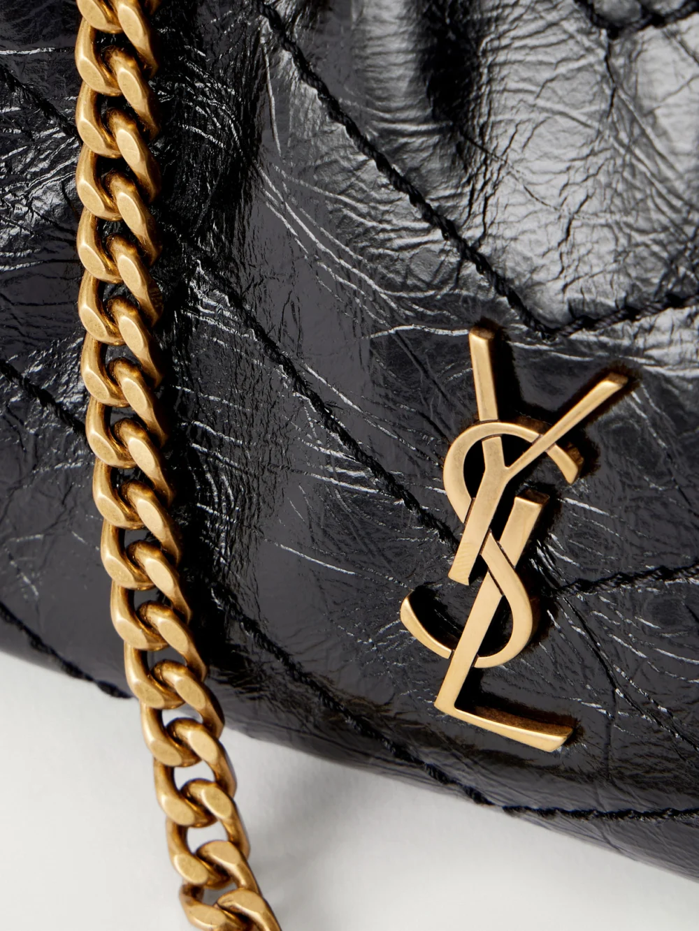 Close-up detail of the Saint Laurent Niki Cassndre-embellished Matelassé Crinkled-leather Shoulder Bag