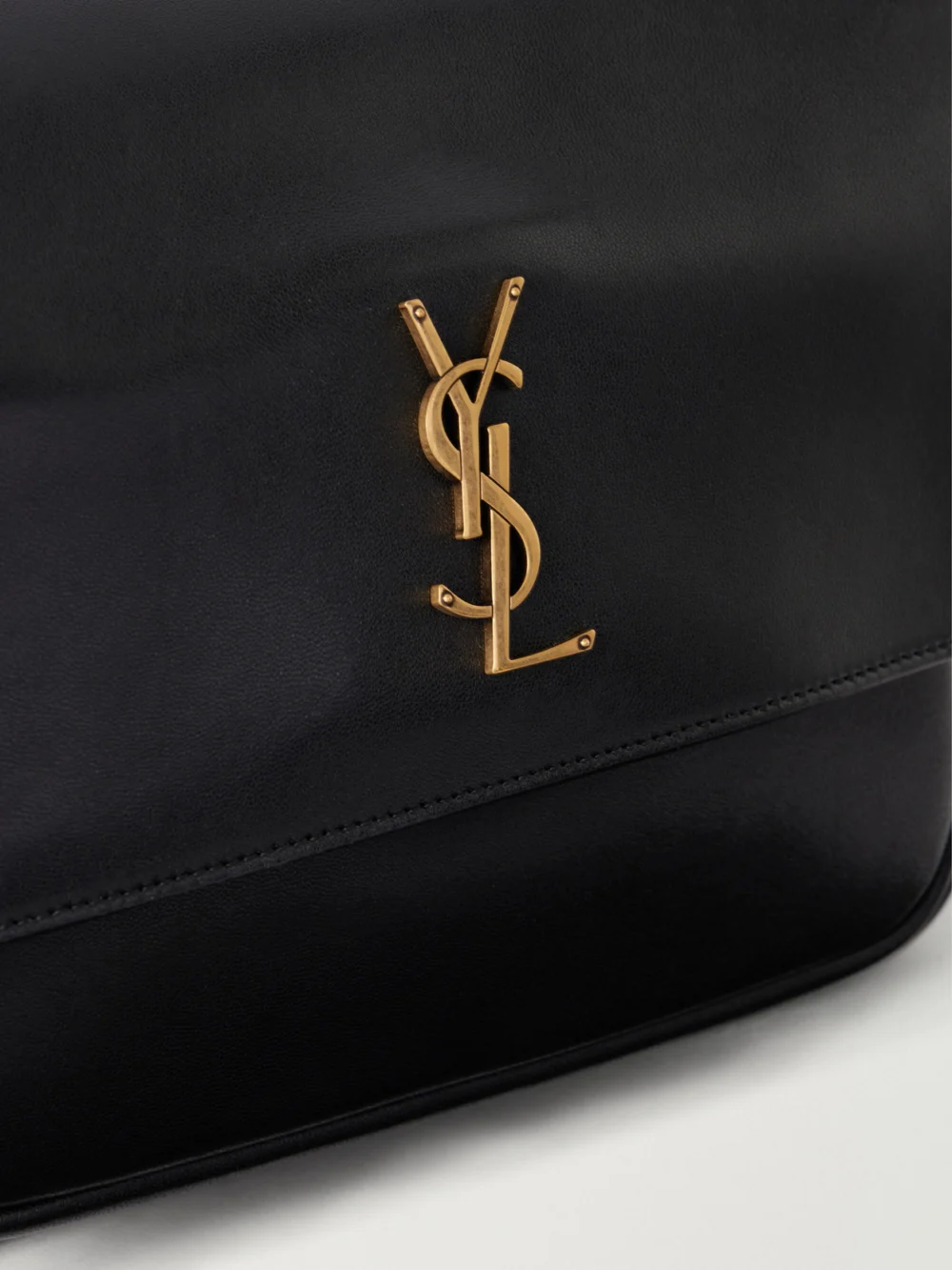 Close-up detail of the Saint Laurent Niki Medium Cassandre-embellished Leather Shoulder Bag