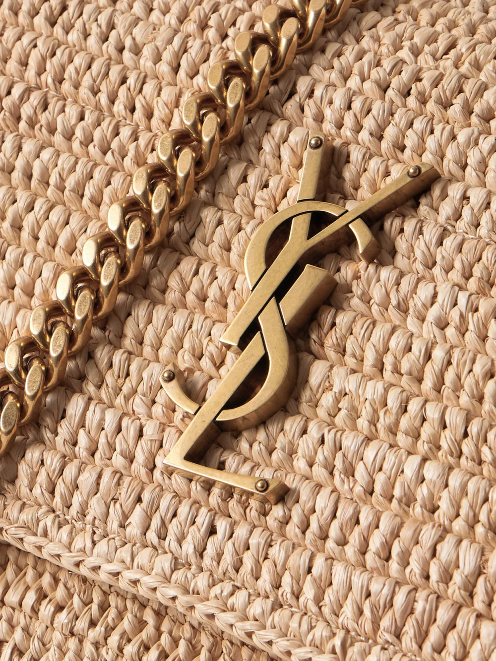 Close-up detail of the Saint Laurent Niki Medium Leather-trimmed Raffia Shoulder Bag