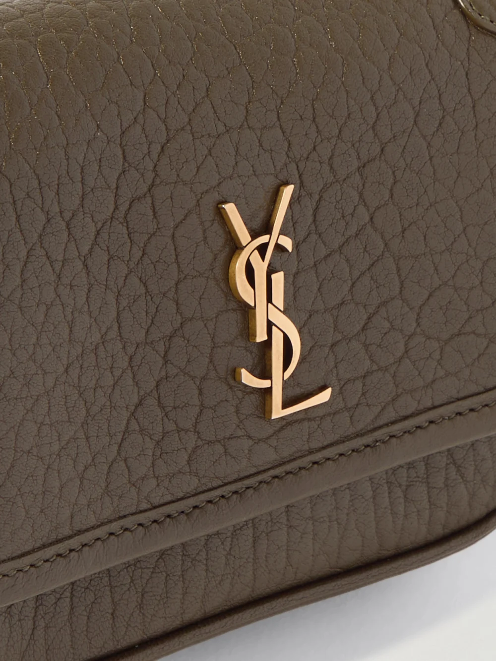 Close-up detail of the Saint Laurent Niki Mini Cassandre-embellished Crinkled-leather Shoulder Bag