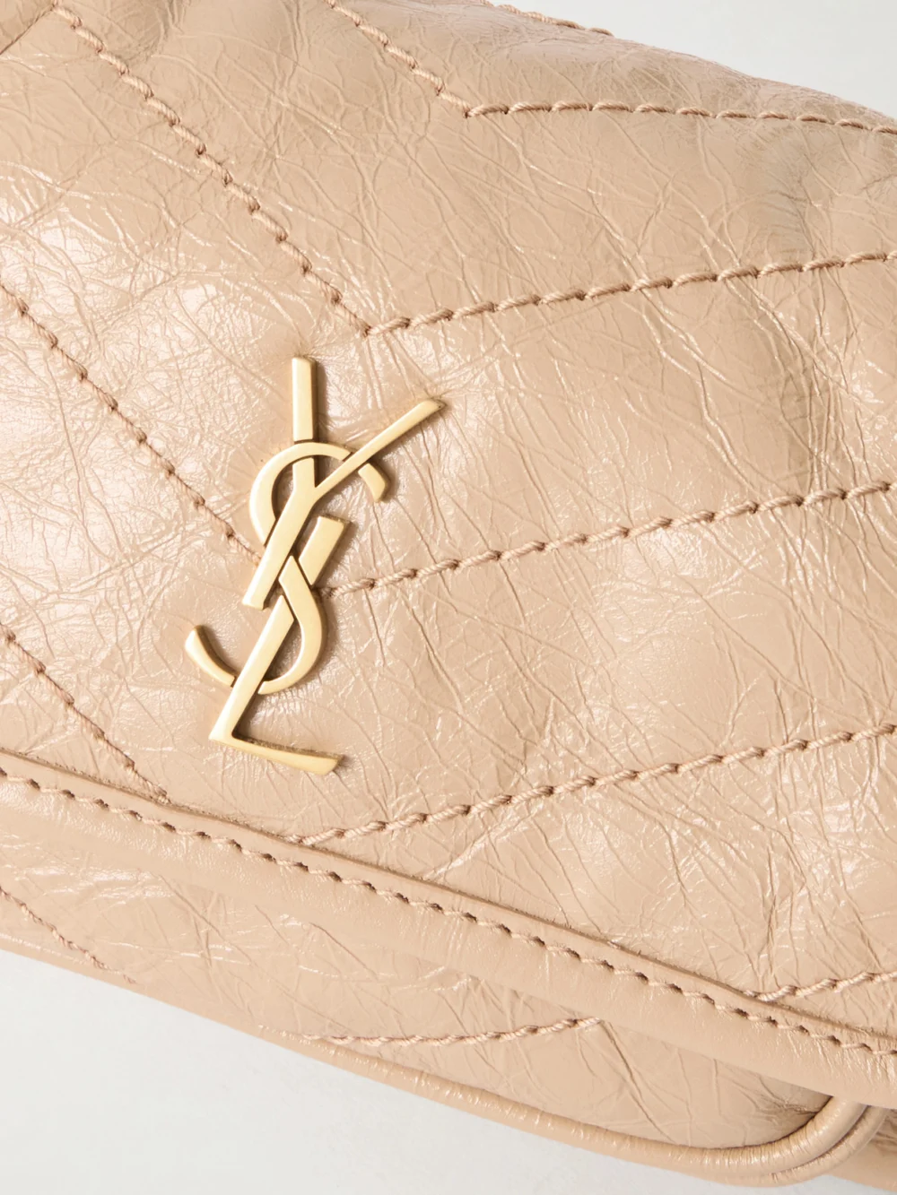 Close-up detail of the Saint Laurent Niki Mini Cassandre-embellished Crinkled-leather Shoulder Bag