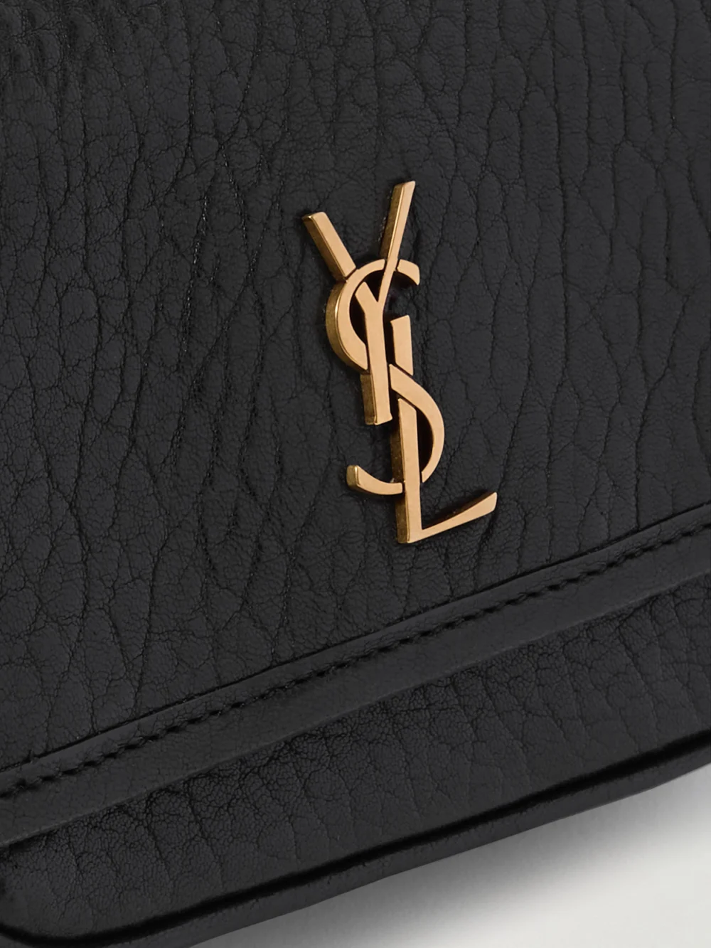 Close-up detail of the Saint Laurent Niki Mini Cassandre-embellished Crinkled-leather Shoulder Bag