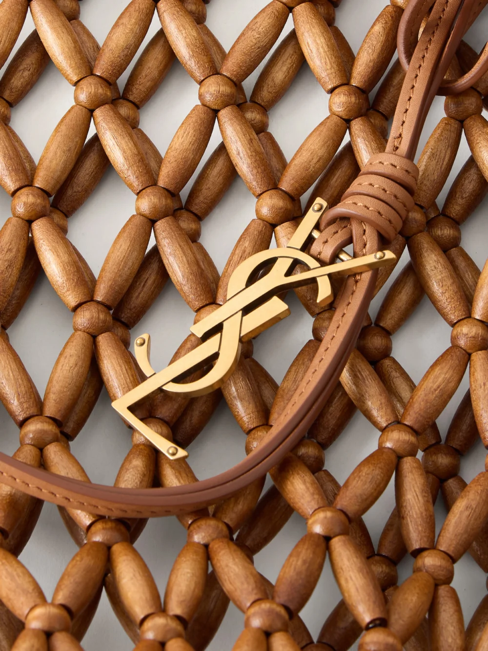 Close-up detail of the Saint Laurent Panier Small Leather-trimmed Beaded Wood Tote