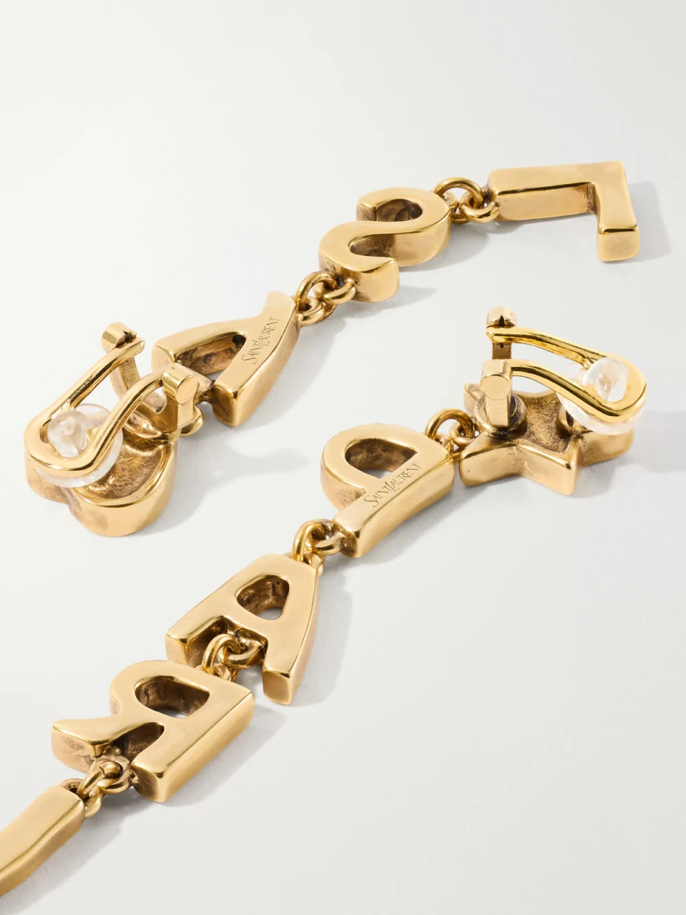 Close-up detail of the Saint Laurent Paris Gold-tone Earrings
