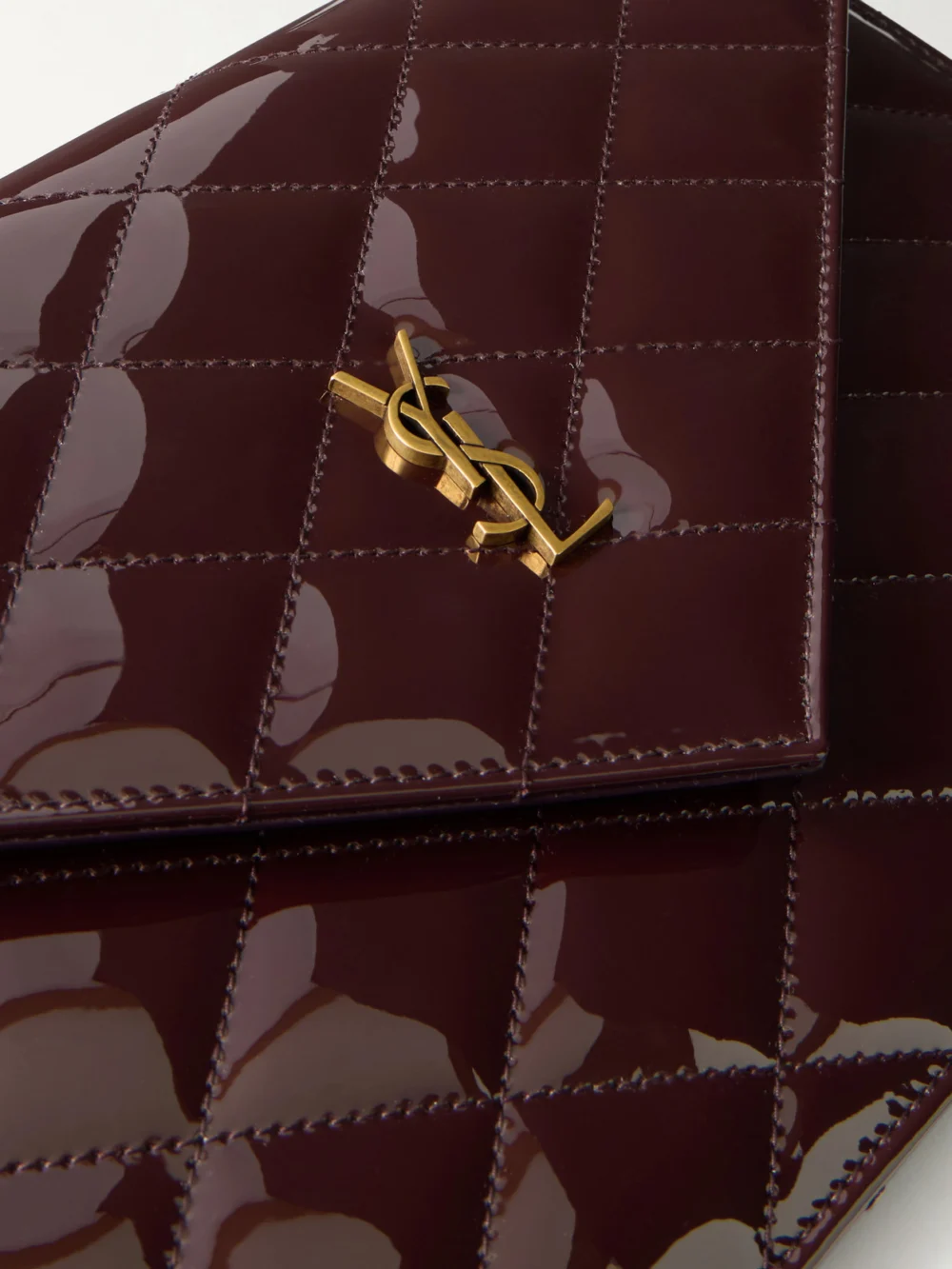 Close-up detail of the Saint Laurent Paris Matelassé Patent-leather Clutch