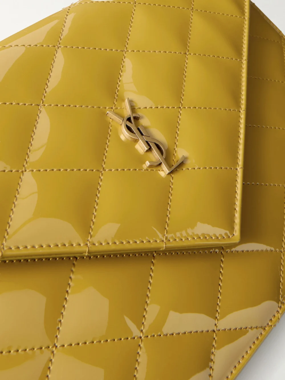 Close-up detail of the Saint Laurent Paris Matelassé Patent-leather Clutch