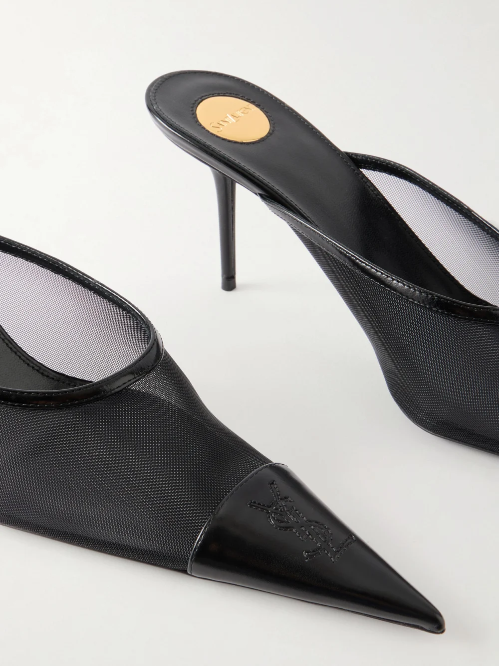 Close-up detail of the Saint Laurent Renée Cassandre-embroidered Patent Leather-trimmed Mesh Mules