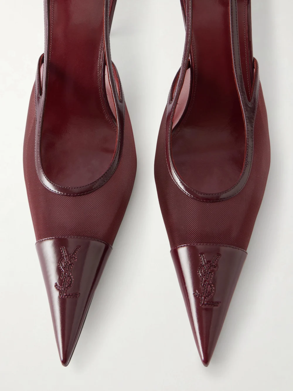Close-up detail of the Saint Laurent Renée Cassandre-embroidered Patent Leather-trimmed Mesh Slingback Pumps