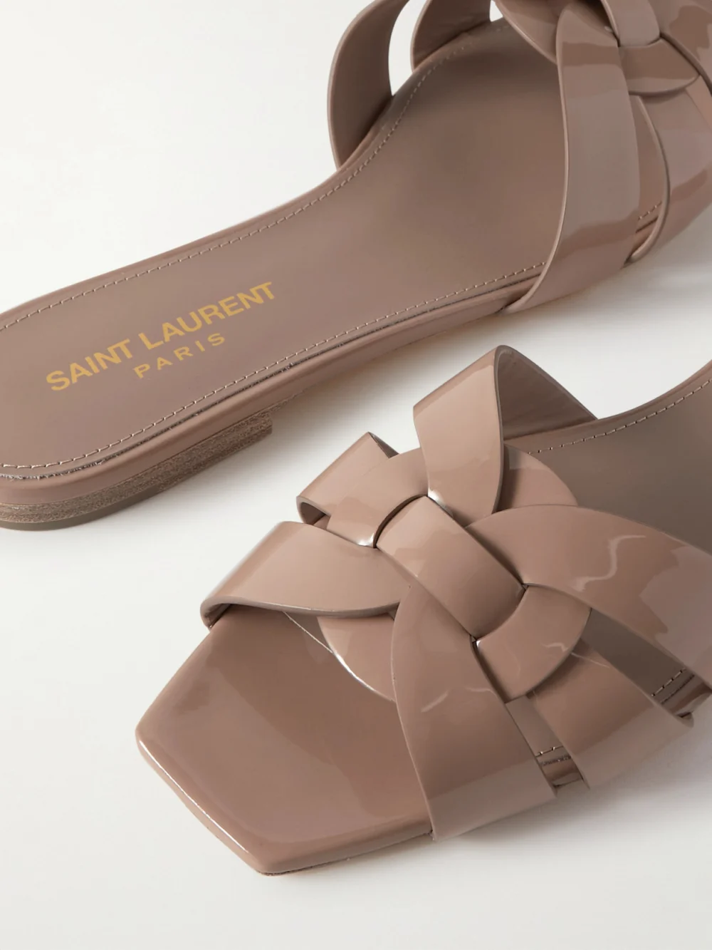 Close-up detail of the Saint Laurent Tribute Woven Patent-leather Slides