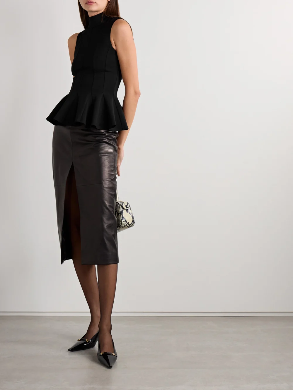 Salon 1884 Ismay Paneled Wool-blend Peplum Turtleneck Top, worn by a model