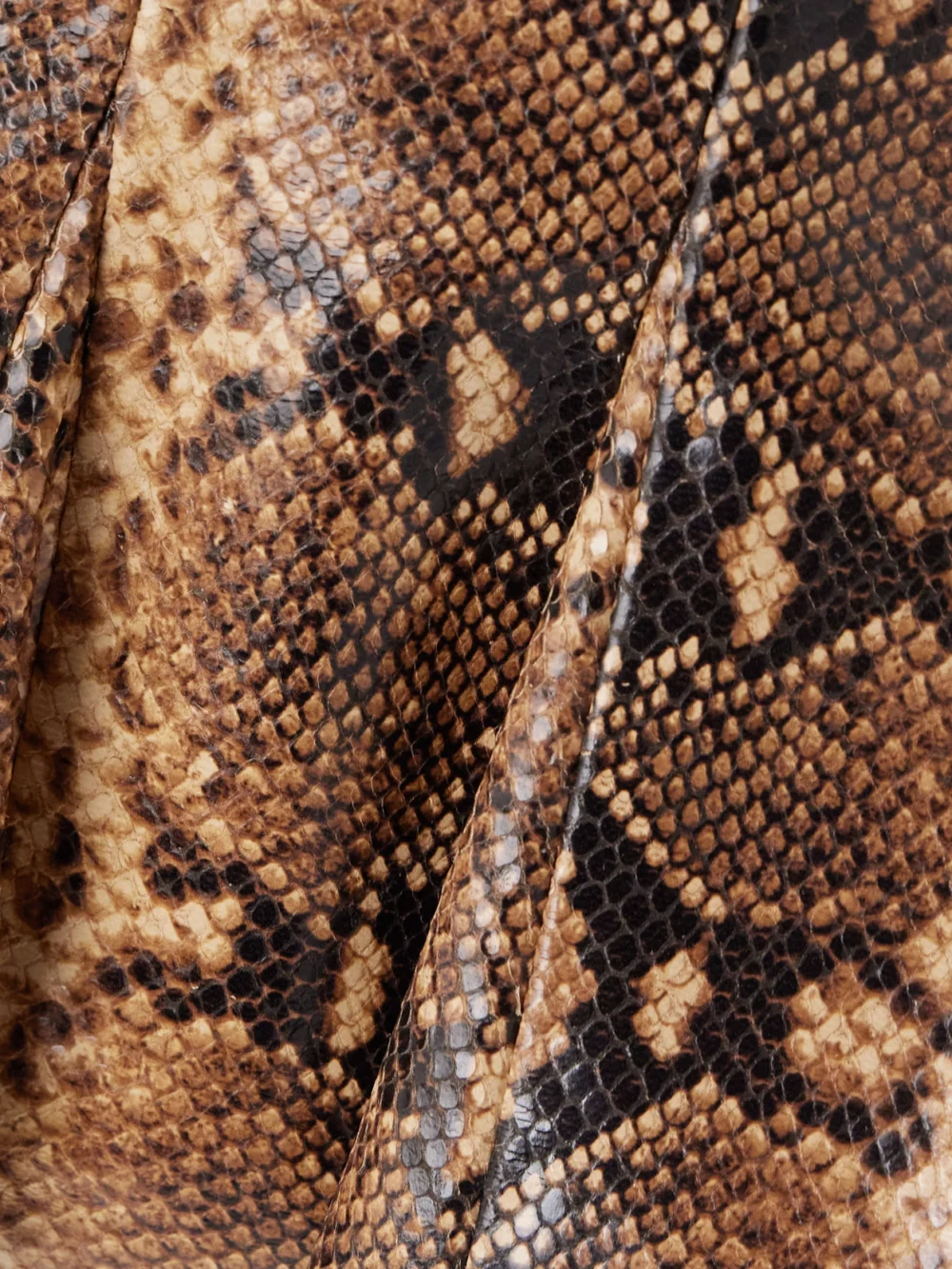Close-up detail of the Salon 1884 Izabel Paneled Snake-effect Leather Peplum Top