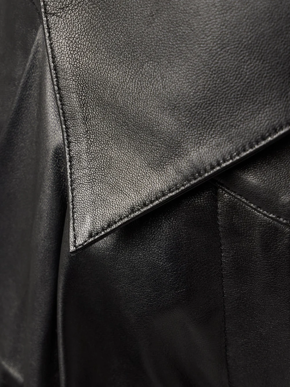 Close-up detail of the Salon 1884 Rekian Pleated Leather Tapered Pants