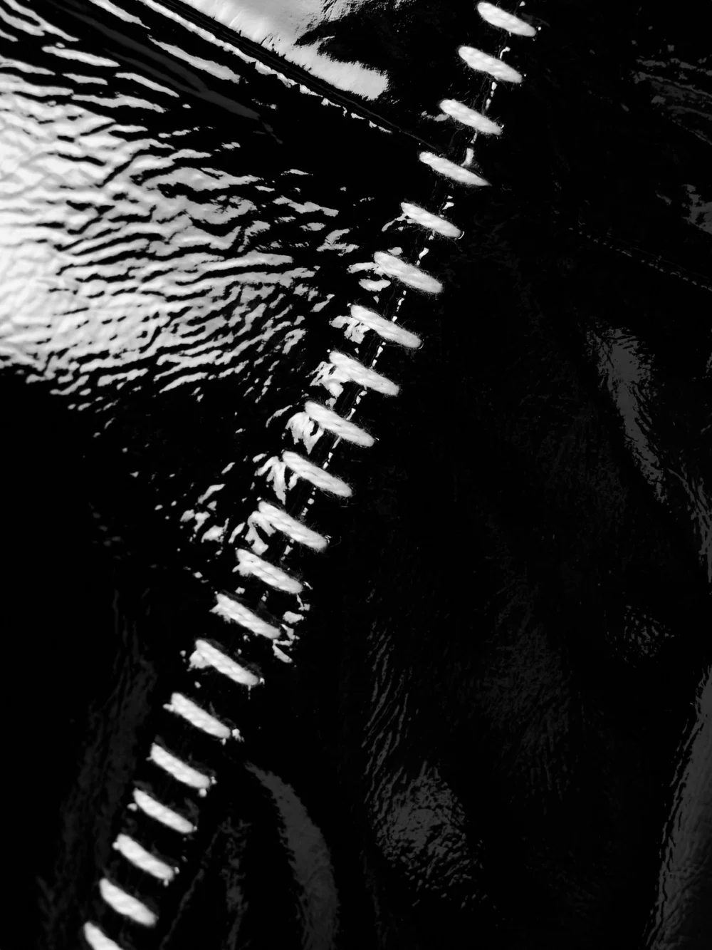 Close-up detail of the Salon 1884 Sioux Strapless Asymmetric Whipstitched Patent-leather Dress