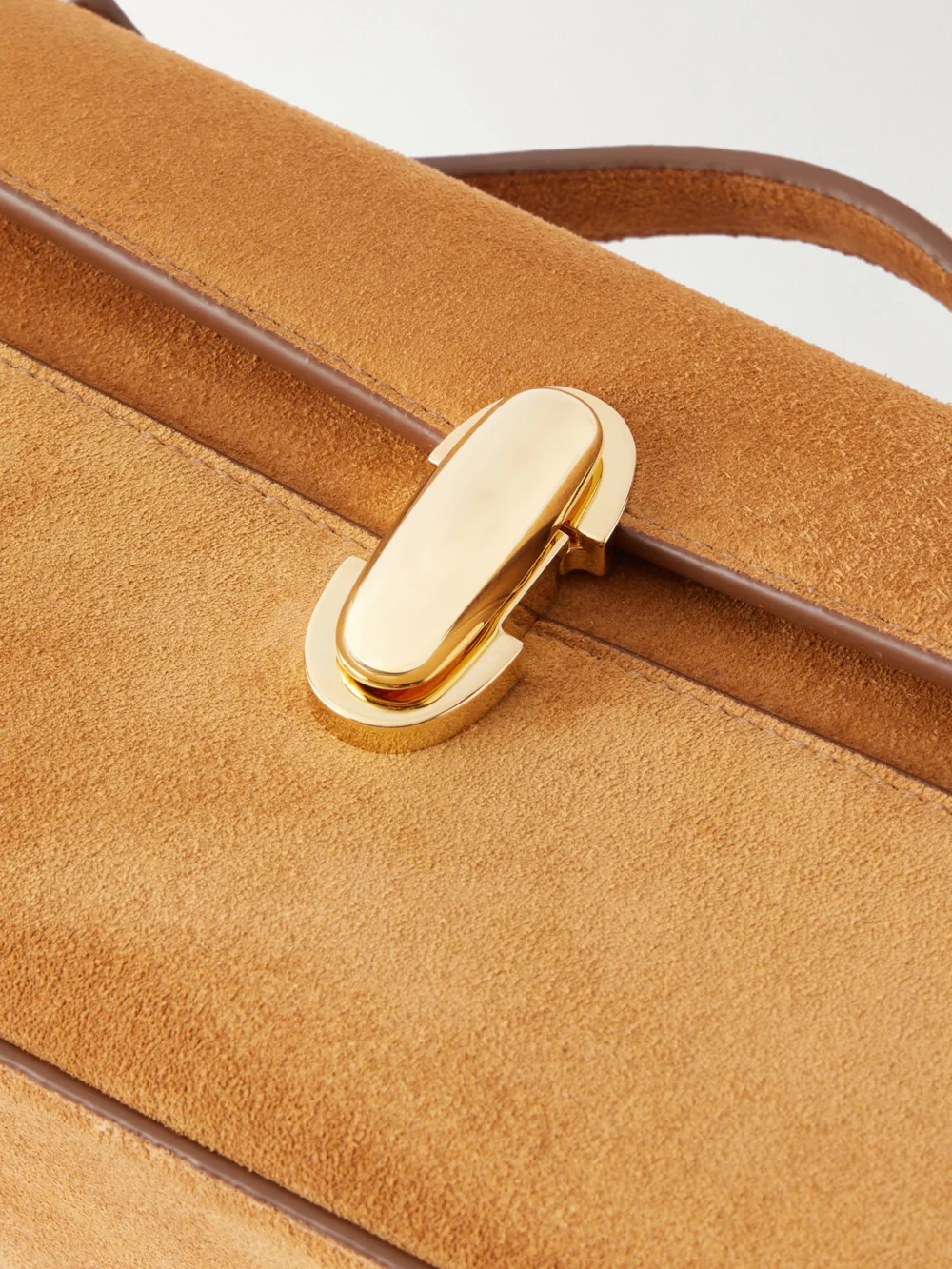 Close-up detail of the Savette Slim Symmetry Pochette Suede Top-handle Bag