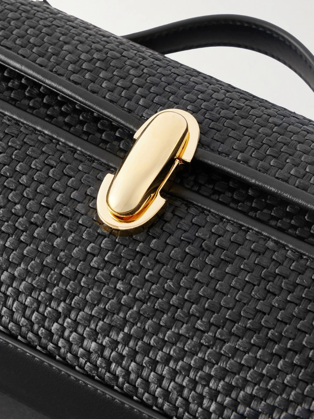 Close-up detail of the Savette Slim Symmetry Woven Leather Top-handle Bag