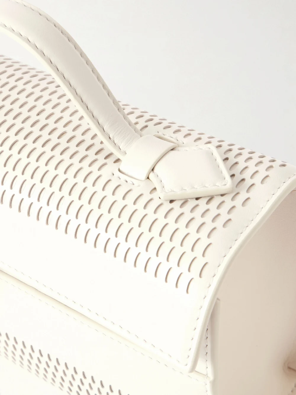 Close-up detail of the Savette Symmetry Laser-cut Leather Top-handle Bag