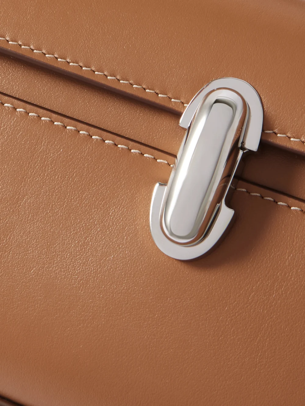Close-up detail of the Savette Symmetry Pochette Leather Top-handle Bag