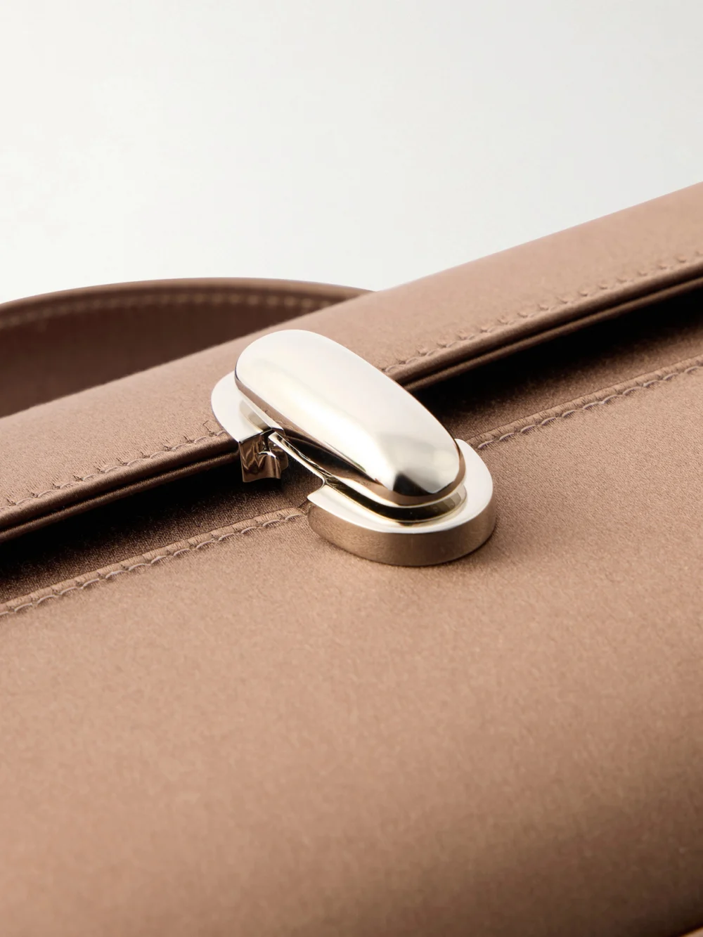 Close-up detail of the Savette Symmetry Pochette Satin Top-handle Bag